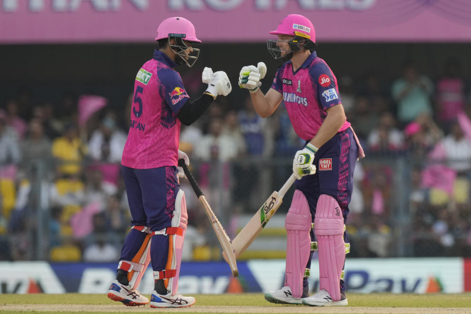 Rajasthan Royals's Jos Buttler, right, celebrates scoring fifty runs with his teammate Ryan Parag during the Indian Premier League (IPL) cricket match between Rajasthan Royals and Delhi Capitals in Guwahati, India, Thursday, April 6, 2023. (AP Photo/Anupam Nath)