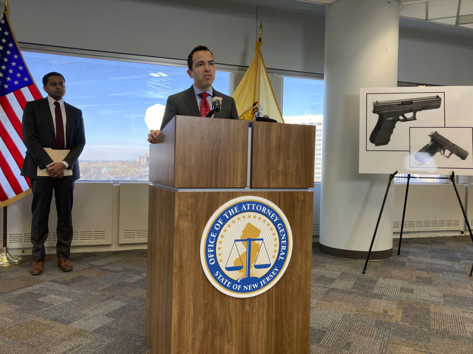 New Jersey Attorney General Matt Platkin, at the lectern, unveils lawsuits against three companies he said violated the state's firearms laws, at his office on Tuesday, Dec. 12, 2023, in Trenton, N.J. The suits were the first brought by his office under a 2022 law aimed at holding gun dealers accountable by allowing the attorney general to sue under New Jersey's public nuisance laws. (AP Photo/Mike Catalini)