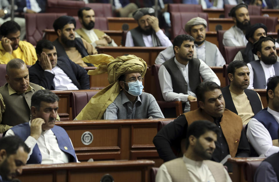 Parliament members listen to a speech by President Ashraf Ghani during the extraordinary meeting of the Parliament in Kabul, Afghanistan, Monday, Aug. 2, 2021. (AP Photo/Rahmat Gul)