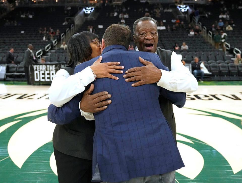 Linda Nation and her husband Hezzie Jack, who are celebrating their 30th wedding anniversary, are greeted by Peter Feigin President of the Milwaukee Bucks and Fiserv Forum, as they are honored on the arena floor before the Milwaukee Bucks game against the Detroit Pistons at Fiserv Forum in Milwaukee, Wis., on Monday, Oct. 31, 2022. Linda, who works in the BMO Club while Hezzie works in BMO guest services, both started working Bradley Center events in the early 2000s and have continued on at Fiserv Forum.