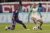 Austin FC midfielder Daniel Pereira, right,moves the ball against FC Dallas forward Tsiki Ntsabeleng, left, during the first half of an MLS soccer match Saturday, May 11, 2024, in Frisco, Texas. (AP Photo/LM Otero)