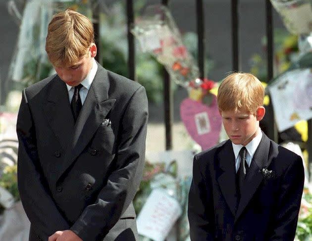 Prince William (left) and Prince Harry, the sons of Diana, Princess of Wales, bow their heads as their mother's coffin is taken out of Westminster Abbey following her funeral service. (Photo: AFP via Getty Images)