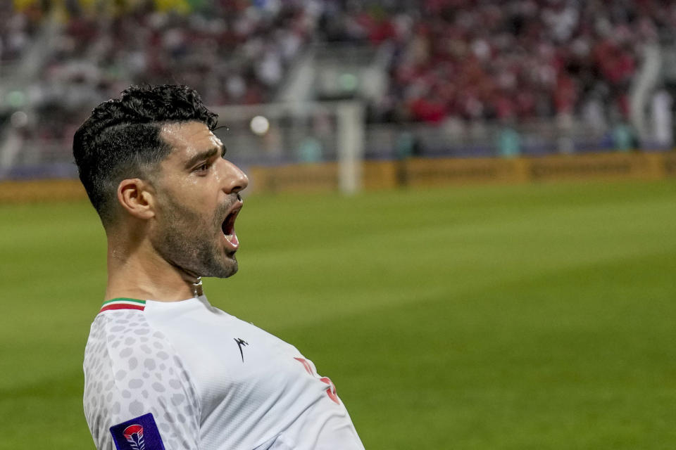 Iran's Mehdi Taremi celebrates after scoring his side's opening goal from a penalty spot during the Asian Cup Round of 16 soccer match between Iran and Syria, at Abdullah Bin Khalifa Stadium in Doha, Qatar, Wednesday, Jan. 31, 2024. (AP Photo/Aijaz Rahi)