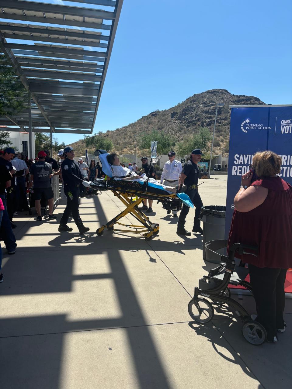 A Donald Trump supporter was stretchered away from Dream City Church in north Phoenix on June 6, 2024. Temperatures outside the venue were in the mid 90s by 10 a.m.