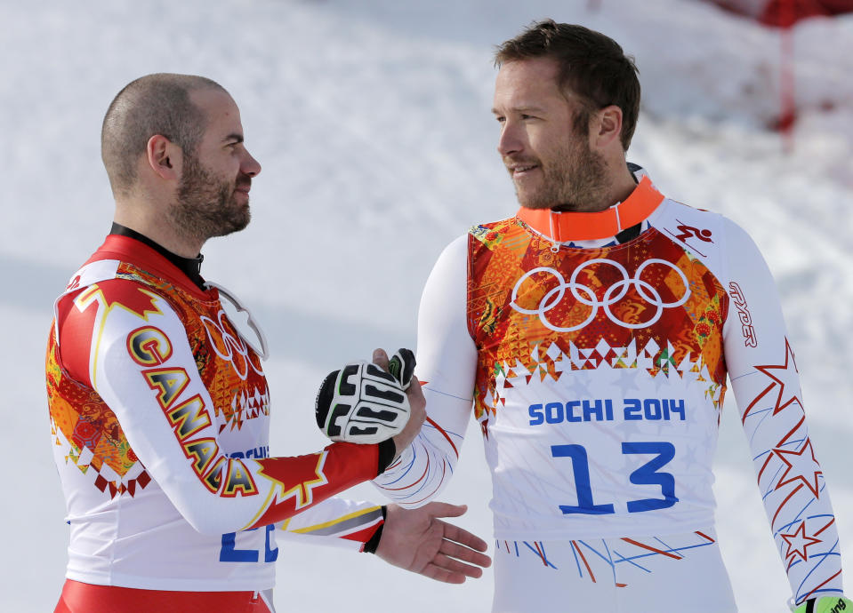 Men's super-G joint bronze medal winners Canada's Jan Hudec and United States' Bode Miller shake hands on the podium during a flower ceremony at the Sochi 2014 Winter Olympics, Sunday, Feb. 16, 2014, in Krasnaya Polyana, Russia. (AP Photo/Christophe Ena)