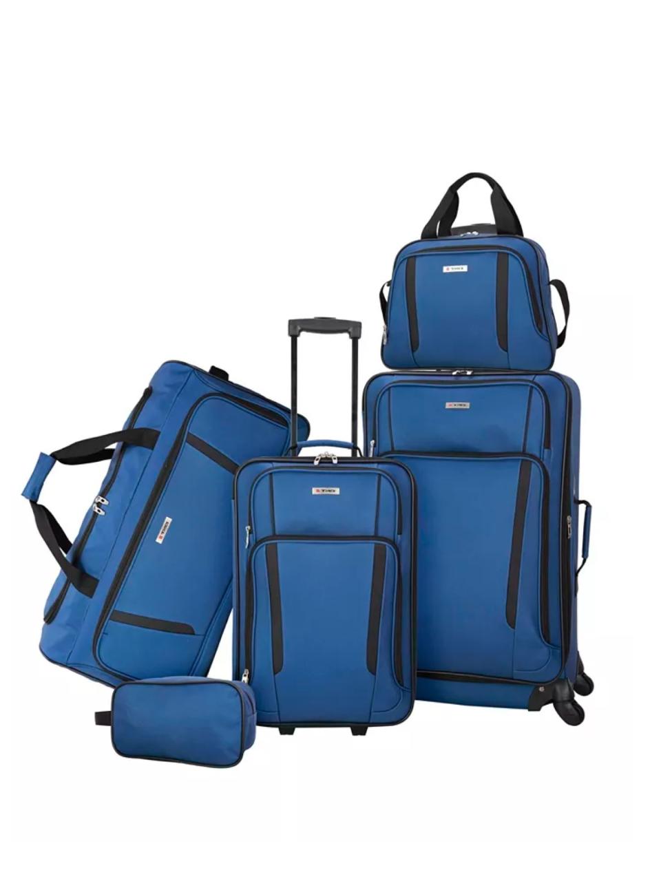 A five-piece set of various sized suitcases next to another