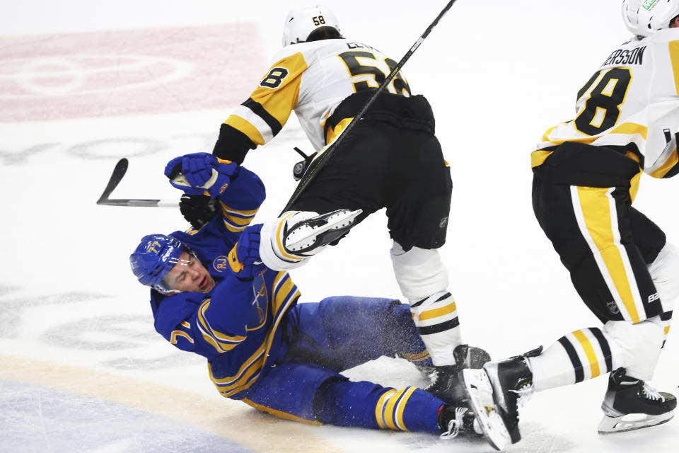 Buffalo Sabres right wing JJ Peterka (77) is checked by Pittsburgh Penguins defenseman Kris Letang (58) during the third period of an NHL hockey game Friday, Nov. 24, 2023, in Buffalo N.Y. (AP Photo/Jeffrey T. Barnes)