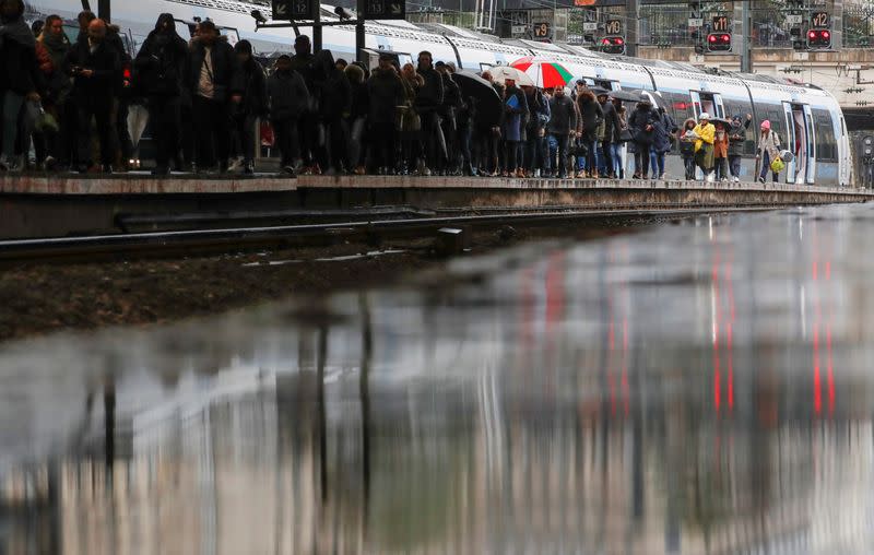 Commuters walk on a platform at Gare Saint-Lazare train station in Paris