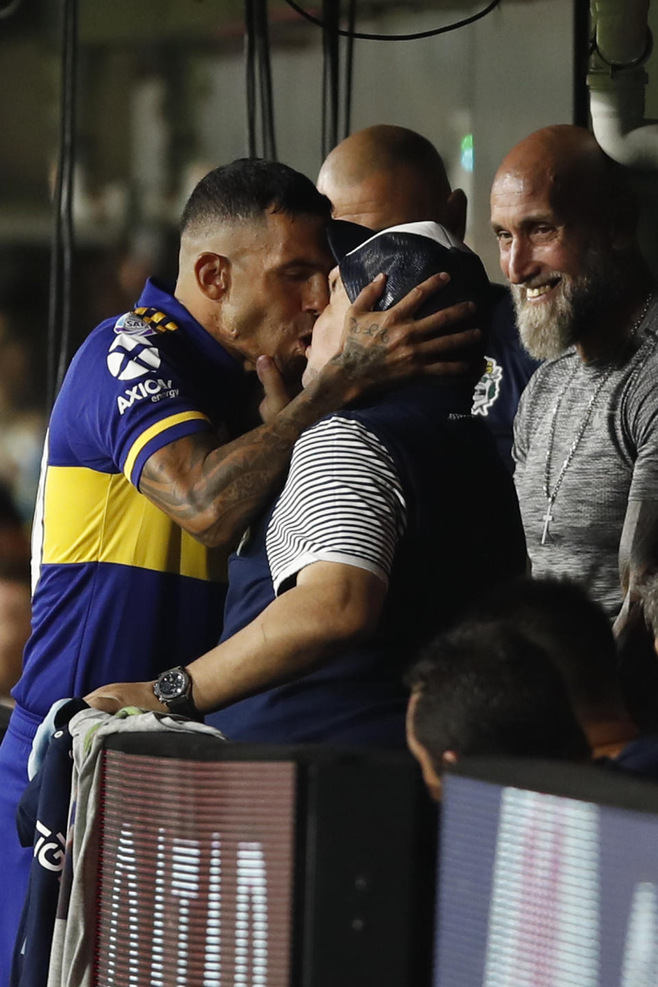 Boca Juniors' Carlos Tevez kisses Gimnasia y Esgrima 's coach Diego Maradona prior to an Argentina's soccer league match at La Bombonera stadium in Buenos Aires, Argentina, Saturday, March 7, 2020. (AP Photo/Natacha Pisarenko)