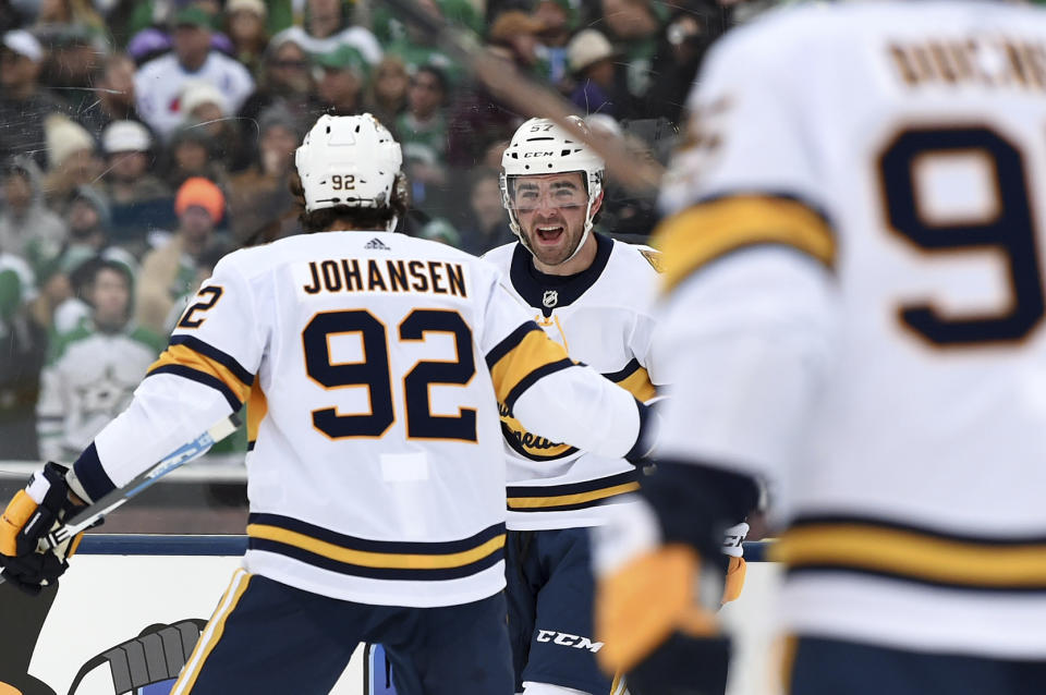 Nashville Predators defenseman Dante Fabbro, center, celebrates with center Ryan Johansen (92) after scoring a goal in the first period of the NHL Winter Classic hockey game at the Cotton Bowl, Wednesday, Jan. 1, 2020, in Dallas. (AP Photo/Jeffrey McWhorter)