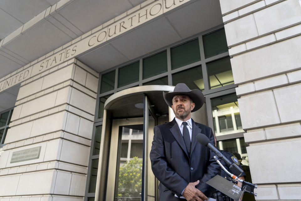 Otero County, New Mexico Commissioner Couy Griffin speaks to reporters at federal court in Washington, Friday, June. 17, 2022. Griffin, who is a central figure in a New Mexico county’s refusal to certify recent election results based on debunked conspiracy theories about voting machines, has avoided more jail time for joining the mob that attacked the U.S. Capitol. He was sentenced to 14 days behind bars, which he has already served. (AP Photo/Gemunu Amarasinghe)