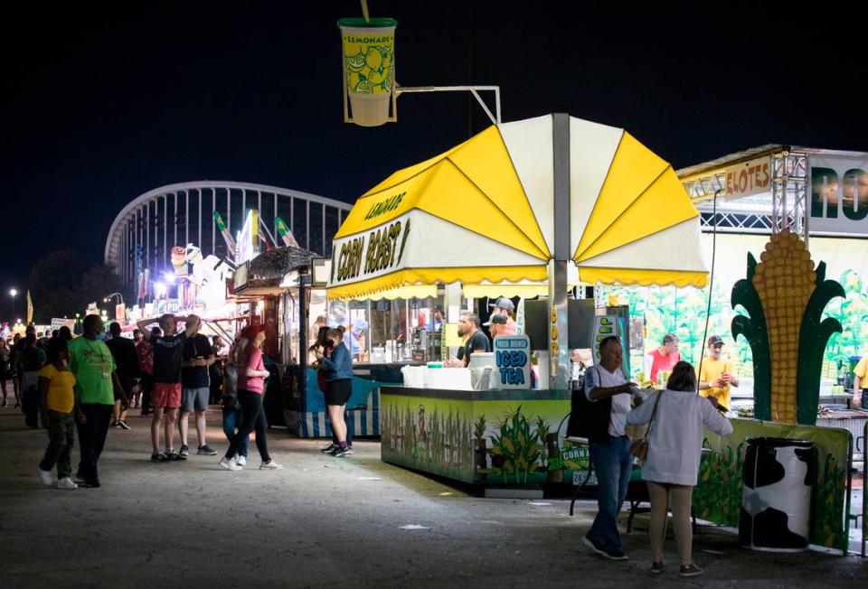 Patrons of the North Carolina State Fair enjoy fair food in Raleigh, N.C. on opening night, Thursday, Oct. 14, 2021.