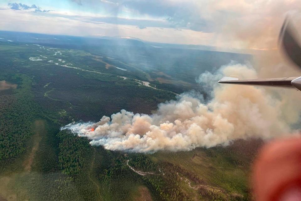 In this aerial photo provided by the Alaska Division of Forestry is the Kichatna fire burning west of Talkeetna, Alaska, on Monday, June 6, 2022. Crews were battling the fire and working to protect nine structures that were near the blaze. (Alaska Division of Forestry via AP) ORG XMIT: FX211