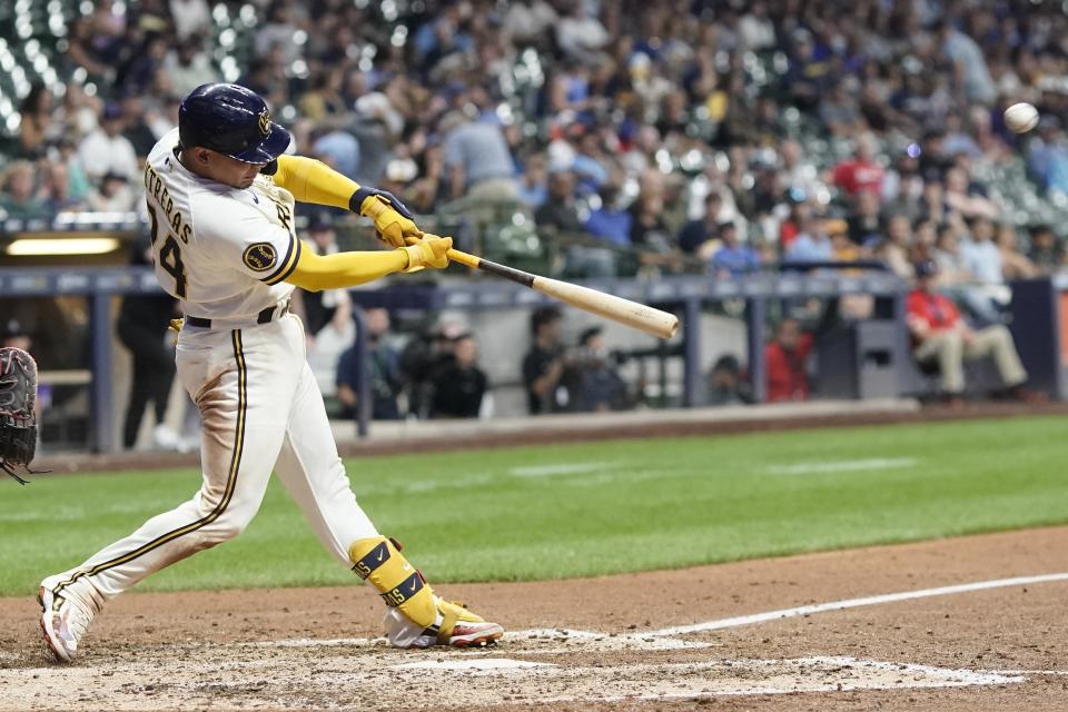 Milwaukee Brewers' William Contreras hits an RBI double during the seventh inning of a baseball game against the Colorado Rockies Monday, Aug. 7, 2023, in Milwaukee. (AP Photo/Morry Gash)