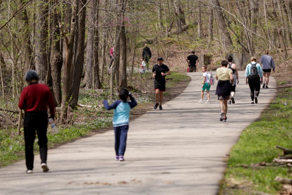 Multiple groups walk along the Wabash Heritage Trail in Happy Hollow Park, Friday, April 24, 2020 in West Lafayette. 
