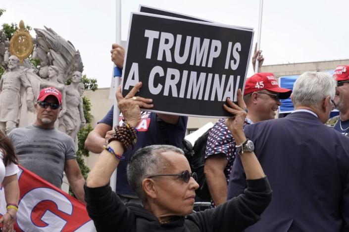 Protesters gather near the E. Barrett Prettyman U.S. Federal Courthouse, Thursday, Aug. 3, 2023, in Washington. (AP Photo/Mariam Zuhaib)