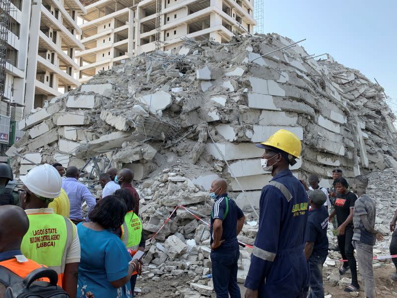 Emergency personnel stands by the debris of the collapsed building in Ikoyi