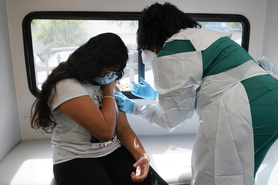 Jenna Ramkhelawan, 12, receives the first dose of the Pfizer Covid-19 vaccine from LPN nurse Dolores Fye, Tuesday, May 18, 2021, in Miami. (AP Photo/Marta Lavandier)