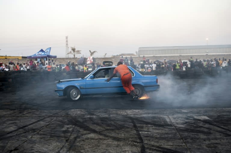 A spinner from the "Spirit Spirit" crew jumps back into a moving car at the Midway spinning event in Soweto, on September 26, 2015