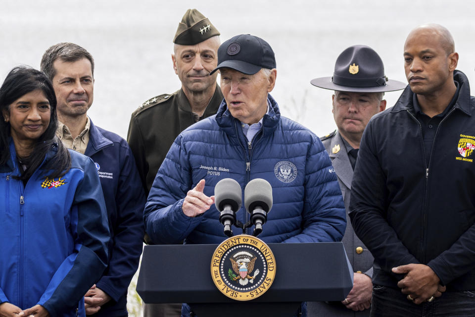 President Joe Biden speaks as Maryland Gov. Wes Moore, right, listens after an operational briefing on the response and recovery efforts of the collapsed Francis Scott Key Bridge, Friday, April 5, 2024, in Dundalk, Md. Looking on at second left is Transportation Secretary Pete Buttigieg. (AP Photo/Julia Nikhinson)