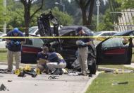 Local police and FBI investigators collect evidence and survey the scene where two gunmen were shot dead, after their bodies were removed in Garland, Texas May 4, 2015. REUTERS/Laura Buckman