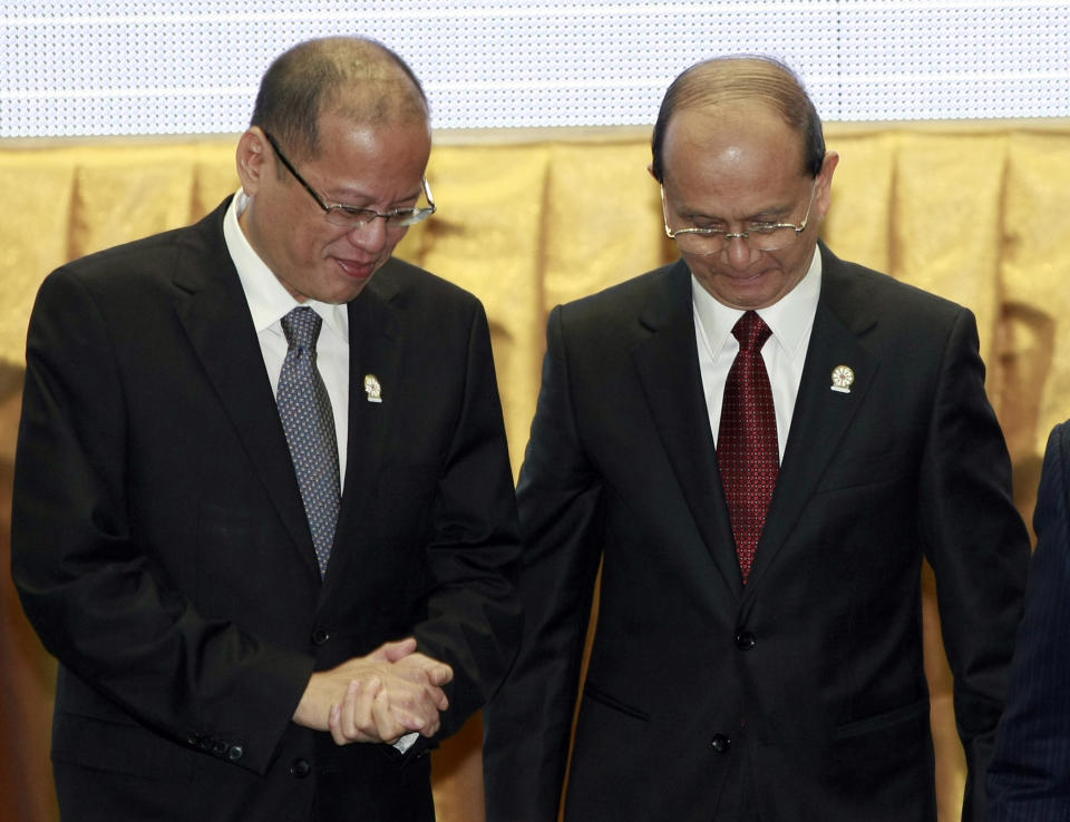 Philippines' President Benigno Aquino III, left, talks with Myanmar President Thein Sein after a group photograph at the opening ceremony of the 20th ASEAN Summit in Phnom Penh, Cambodia Tuesday, April 3, 2012. (AP Photo/Apichart Weerawong)