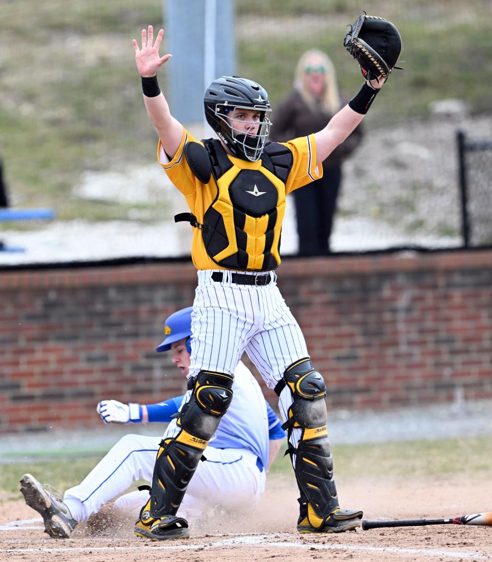 Logan Our of St. John Paul II crosses the plate as Nauset catcher Evan Archer calls off the throw.
(Credit: Ron Schloerb/Cape Cod Times)