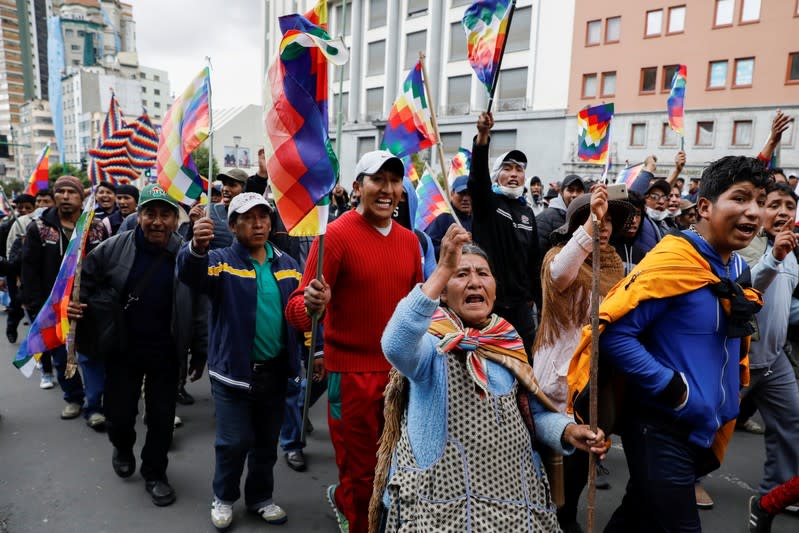 Supporters of Bolivia's ousted President Evo Morales hold Wiphala flags as they take part in a protest, in La Paz