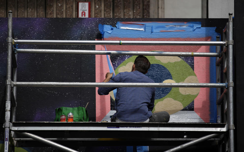 BRISTOL, ENGLAND - AUGUST 17: An artist continues to work on part of the 'See No Evil' street art project at Nelson Street on August 17, 2012 in Bristol, England. The project, now in its second year, is Europe's biggest street art festival and has attracted top graffiti artists from all over the world. Organizers hope it will continue to be a draw for tourists visiting Bristol, often seen the spiritual home of underground artist Banksy. (Photo by Matt Cardy/Getty Images)