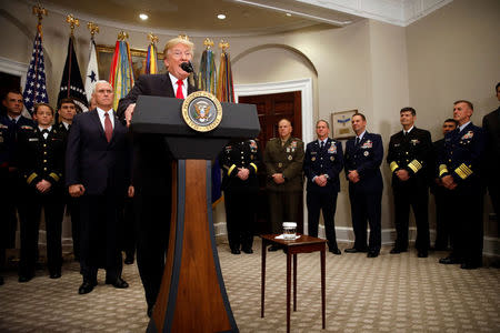 U.S. President Donald Trump speaks during the signing ceremony of the National Defense Authorization Act for Fiscal Year 2018, accompanied by Vice President Mike Pence and members of the military, at the White House in Washington D.C., U.S. December 12, 2017. REUTERS/Carlos Barria