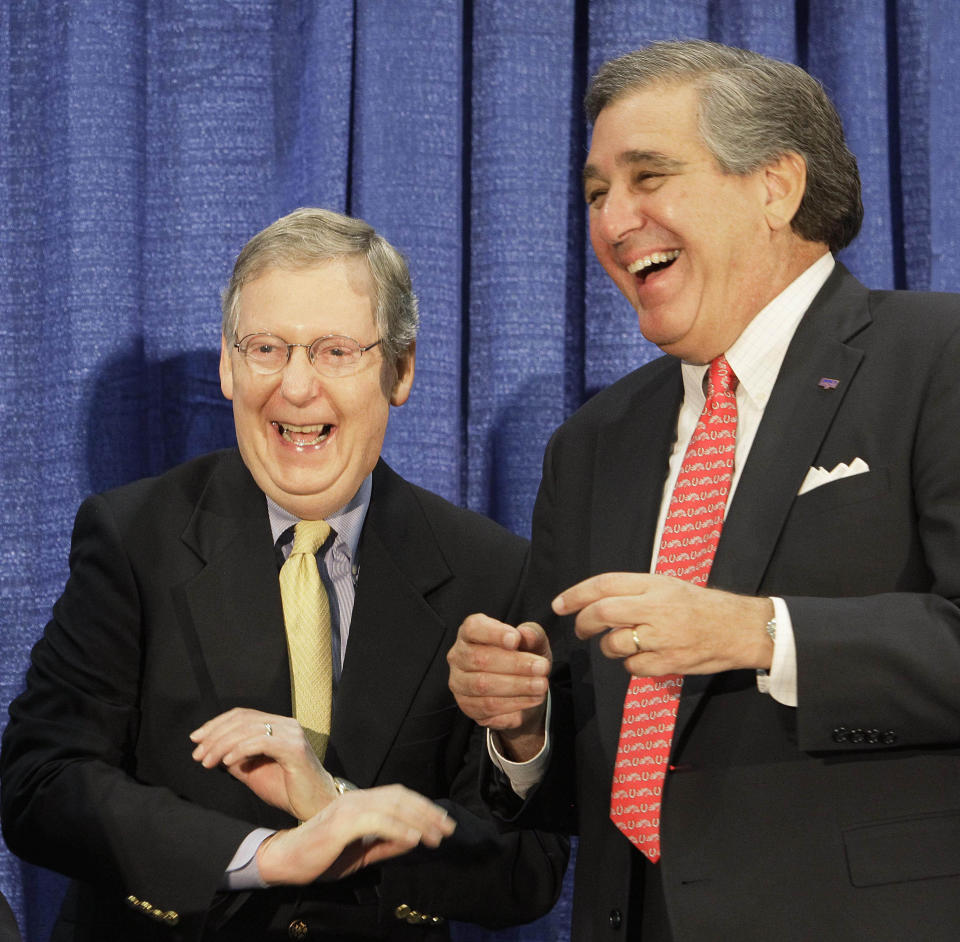 McConnell laughs with Louisville Mayor Jerry Abramson at the annual ham breakfast at the Kentucky State Fair in Louisville, Ky., in 2010. (AP Photo/Ed Reinke)