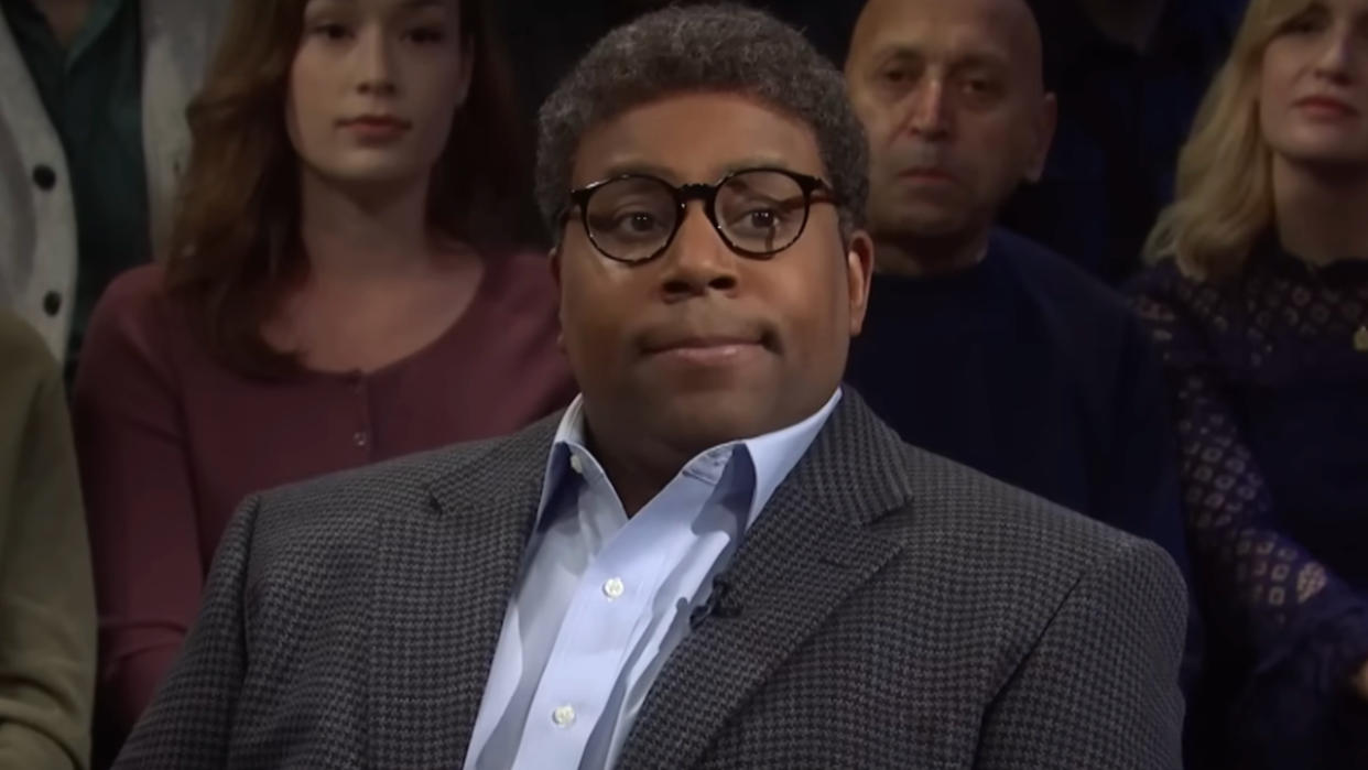  Kenan Thompson sits with a straight face during a sketch on SNL. 