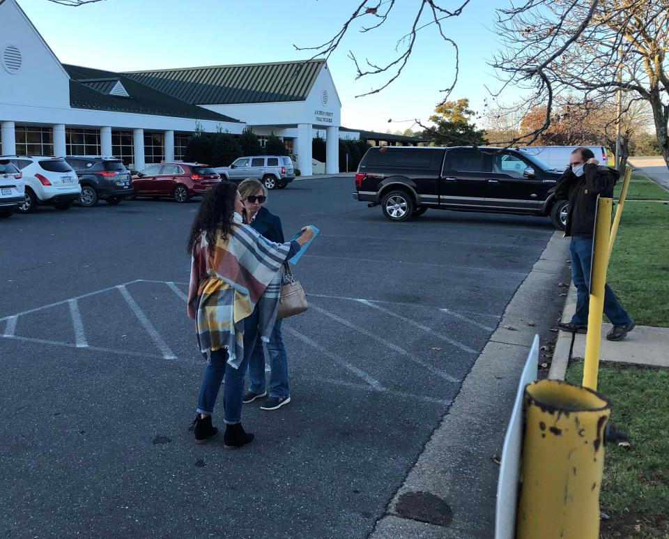 Sonia Velasquez Shifflett (left) with the Republican Party hands out sample ballots at the Augusta County Government Center in Verona Tuesday morning as voters head to the polls.