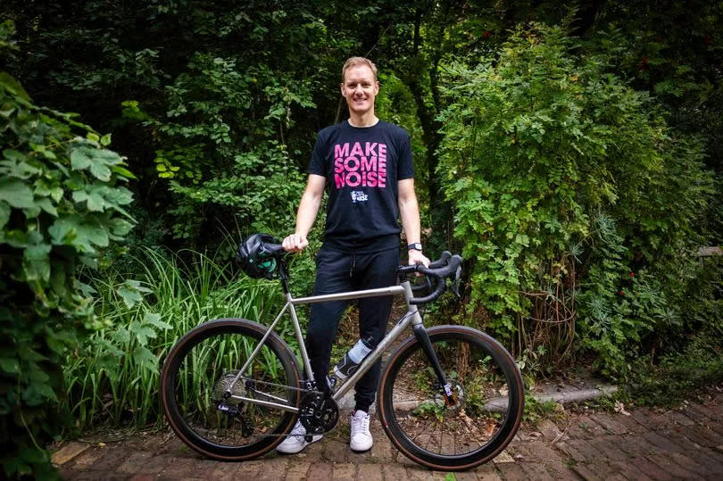 Dan Walker in front of a bike