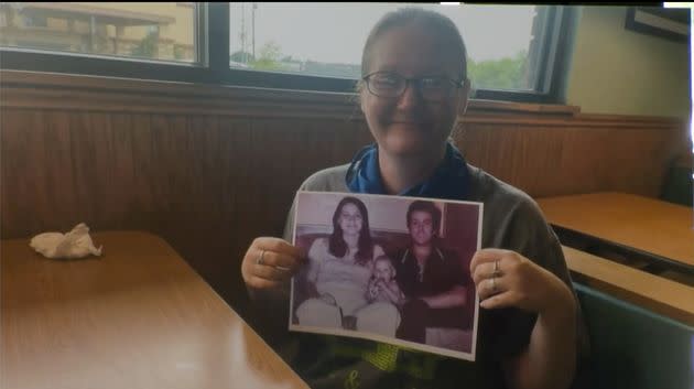 Holly Marie Clouse is seen as an adult holding a photo of her parents and herself as an infant. (Photo: Attorney General of Texas)