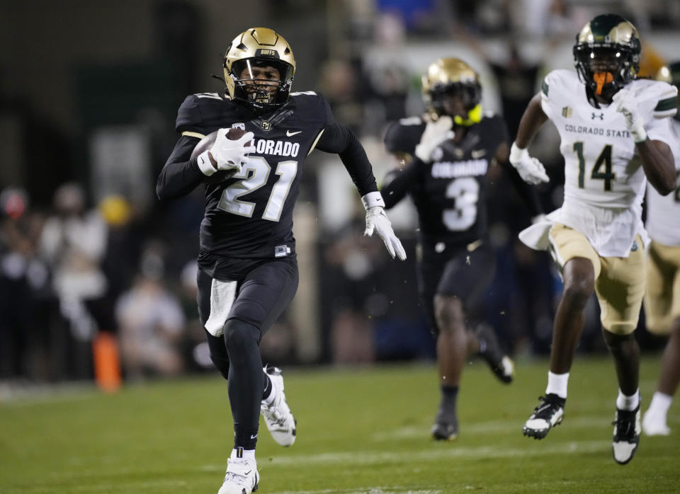 Colorado safety Shilo Sanders, left, runs back an interception for a touchdown as Colorado State wide receiver Tory Horton (14) pursues in the first half of an NCAA college football game Saturday, Sept. 16, 2023, in Boulder, Colo. (AP Photo/David Zalubowski)