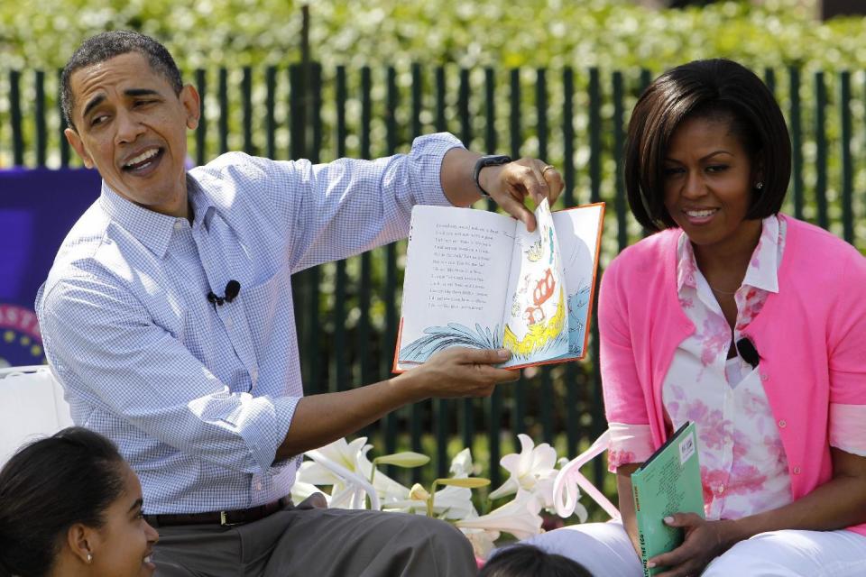 FILE - In this April 5, 2010 file photo, President Barack Obama, accompanied by first lady Michelle Obama and daughter Malia Obama, reads "Green Eggs and Ham", as they hosted the annual White House Easter Egg Roll on the South Lawn of the White House in Washington. What does Michelle Obama do next? After eight years as a high-profile advocate against childhood obesity, a sought-after talk show guest, a Democratic power player and a style maven, the first lady will have her pick of options when she leaves the White House next month.(AP Photo/Charles Dharapak, File)