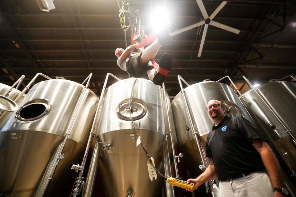 The owners of Memphis Made Brewing Co. Drew Barton, left, and Andy Ashby, right, pose for a photo inside of their new, second location at 16 S. Lauderdale Street in Memphis, Tenn. on September 21, 2023.
