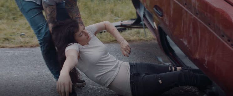 The character of Alice, played by Emmeline Kellie, is dragged from the car (AA Charitable Trust) 
