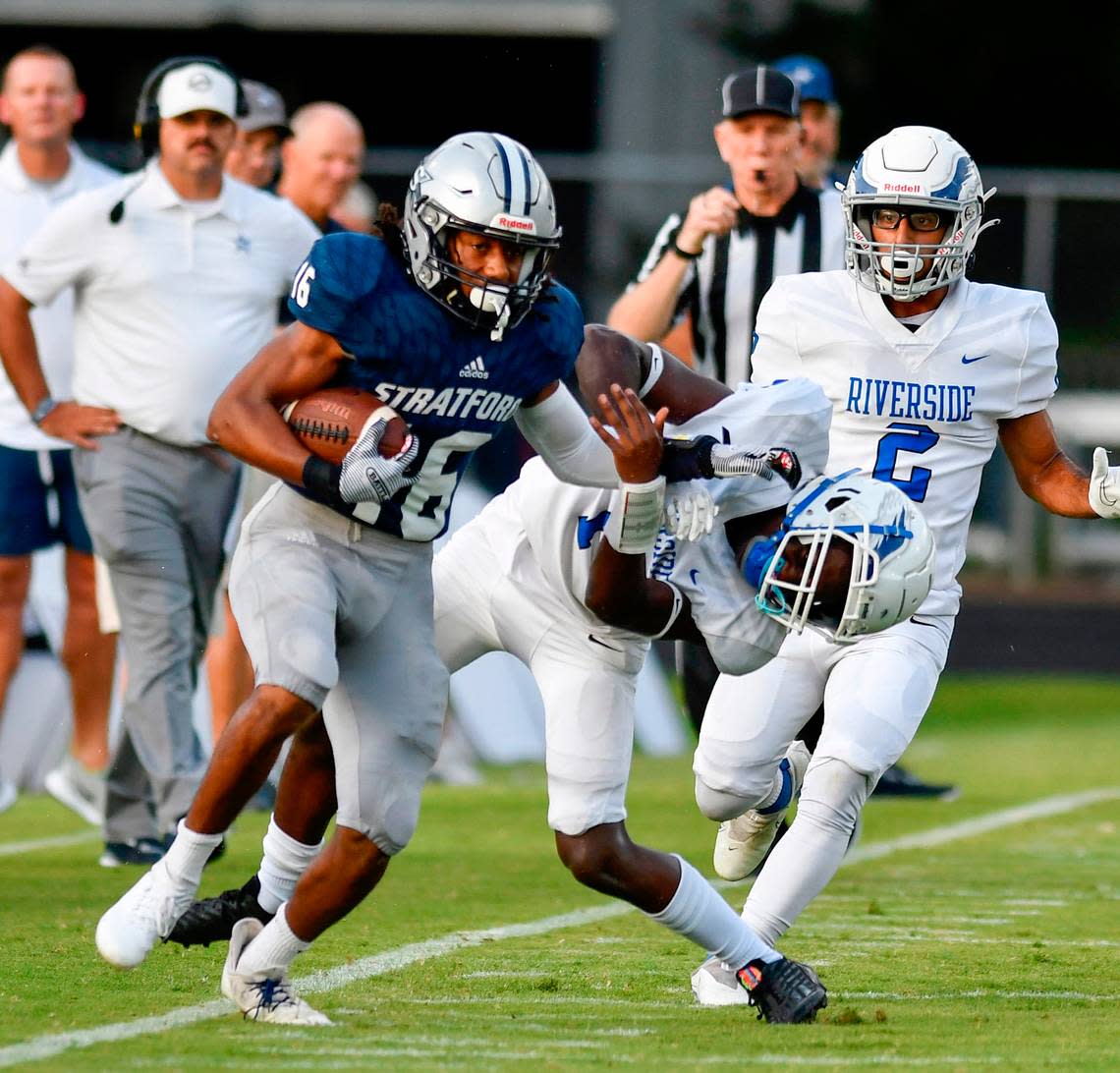 Stratford’s Shaun Wilmore (16) gives a stiff arm to a Riverside Military Academy defender while running down the sideline during the Eagles’ 42-20 win Thursday night.