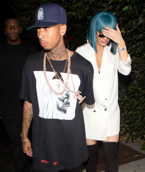 Kylie Jenner is doing her own thing, and she doesn't care what people think -- not even her half-sister Kourtney Kardashian. On Friday night, Kylie rocked a blue wig with short bangs while hanging out with her boyfriend Tyga and Kourtney's ex, Scott Disick, at the West Hollywood nightclub 1 OAK. Splash News The 18-year-old reality star was photographed with Tyga and Scott outside the club, wearing dark, round shades and trying to stay out of the paparazzi pics. <strong>WATCH: Tyga Shares Super Sexy Photo of Kylie Jenner on Her 18th Birthday </strong> Kylie kept up the blue wig look on Saturday night as well when she hit the town with her friends, including model Chantell Jeffries. The blue theme was also evident in her wardrobe, as she sported a button-down denim top and some ripped denim short-shorts that showed a flash of her butt. Splash News The <em>Keeping Up With the Kardashians</em> star also shared a pic of her Louise Brooks-style wig on Instagram on Friday. It's hard to make short blue wigs actually work but Kylie manages to pull it off . WATCH: Kylie Jenner Models Tyga's Boxer Briefs on Snapchat There also doesn't seem to be any bad blood between Kylie and Kourtney after the youngest Jenner sister hung out with Scott. On Sunday night, the sisters posed with mom, Kris Jenner, at the 2015 MTV Video Music Awards. Getty Images One thing she hasn't been pulling off is responsible water conservation. Kylie and her boyfriend were reportedly cited for water over consumption at their home in draught-starved California. 