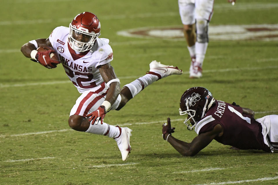 Mississippi State cornerback Martin Emerson (1) trips Arkansas running back Trelon Smith (22) during the second half of an NCAA college football game in Starkville, Miss., Saturday, Oct. 3, 2020. Arkansas won 21-14. (AP Photo/Thomas Graning)