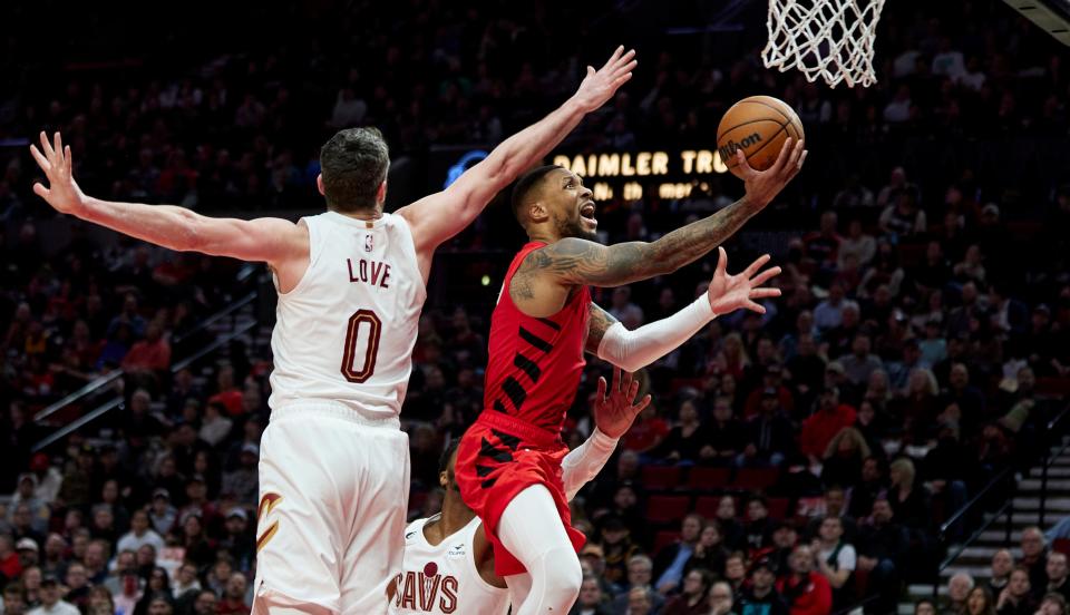 Portland Trail Blazers guard Damian Lillard, right, shoots next to Cleveland Cavaliers forward Kevin Love during the second half of an NBA basketball game in Portland, Ore., Thursday, Jan. 12, 2023. (AP Photo/Craig Mitchelldyer)