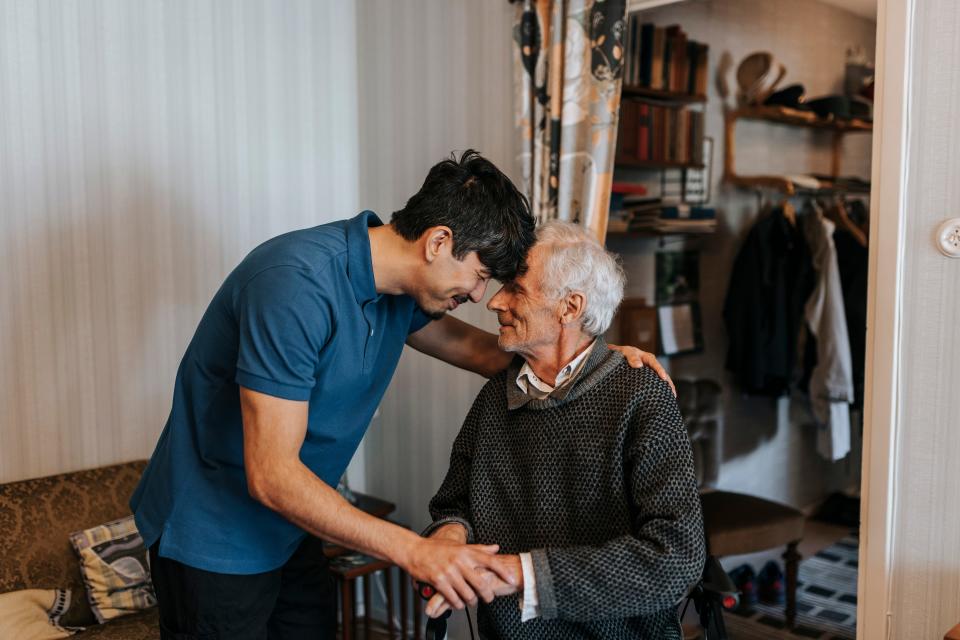 male care assistant with patient.