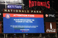 The scoreboard displays a message to fans during a stoppage in play due to an incident near the ballpark in the sixth inning of a baseball game between the Washington Nationals and the San Diego Padres, Saturday, July 17, 2021, in Washington. (AP Photo/Nick Wass)