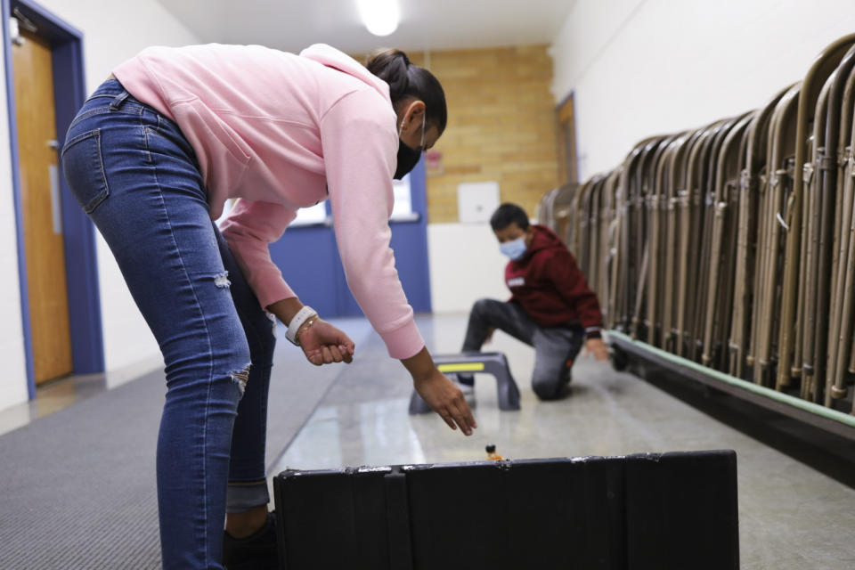 Aylin Garcia Rosa, 9, attempts to get the car she built with her cousin down a ramp and through a 