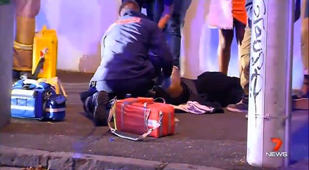 Ambulance officers treat a person hurt in the brawl. Photo: 7 News