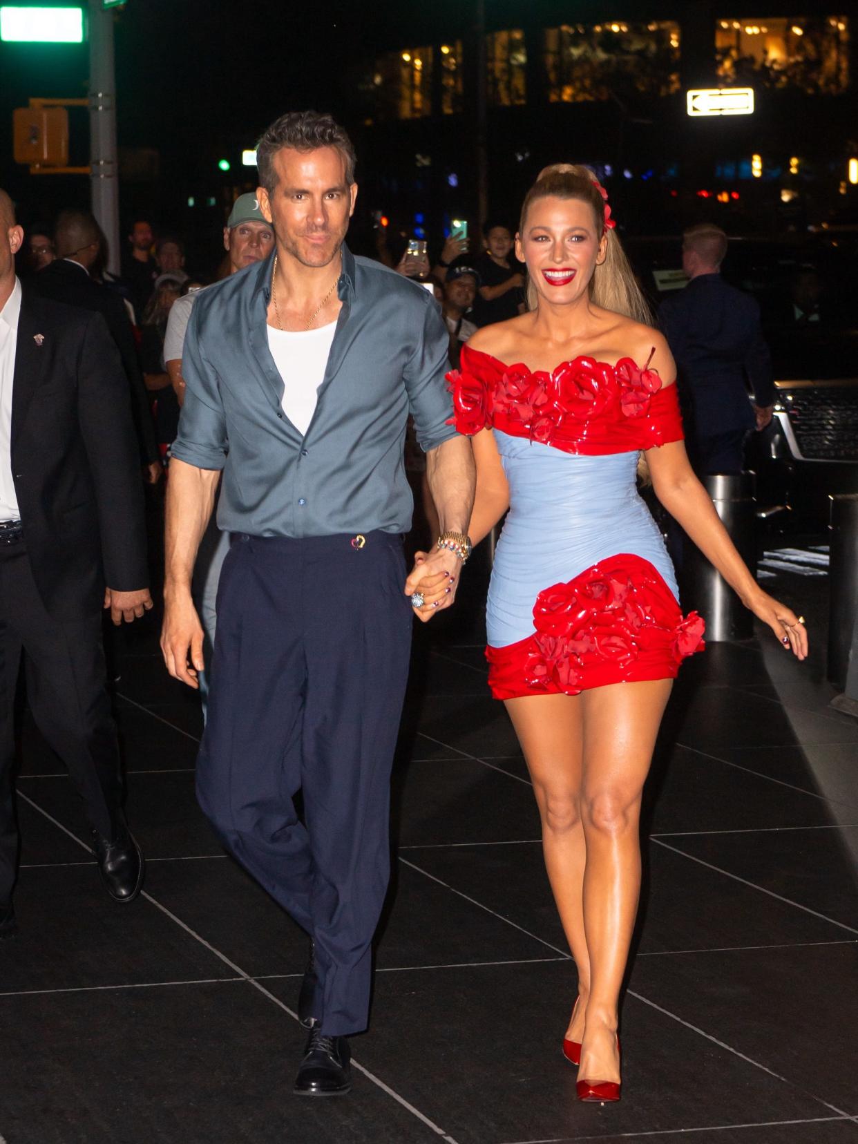 Ryan Reynolds and Blake Lively hold hands and walk down a New York street at night.