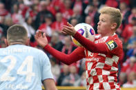 Mainz's Jonathan Burkhardt, right, and Cologne's Jeff Chabot battle for the ball during the Bundesliga soccer match between FSV Mainz 05 and 1. FC Koln at Mewa Arena, Mainz, Germany, Sunday April 28, 2024. (Torsten Silz/dpa via AP)