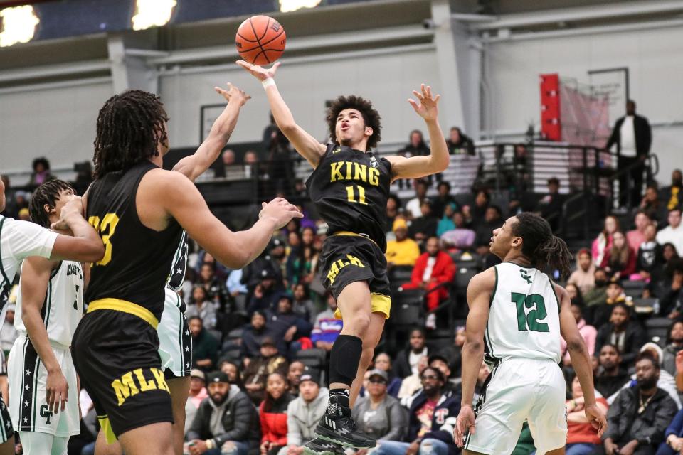 Detroit King's Chas Lewless (11) goes to the basket against Cass Tech  during the second half at the Wayne State Fieldhouse in Detroit on Sunday, February 19, 2023.